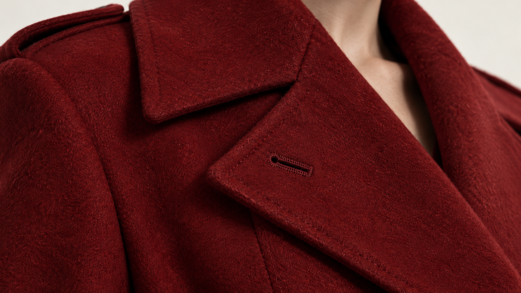 Close view of the crimson wool, lapels, stitching, and buttonhole details.